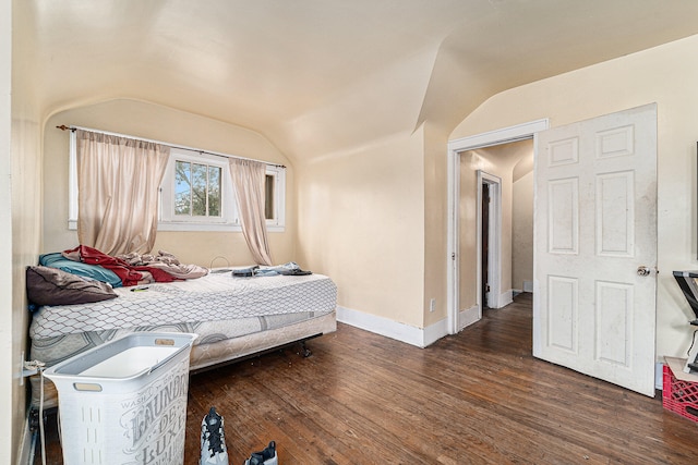 bedroom featuring lofted ceiling and dark hardwood / wood-style flooring