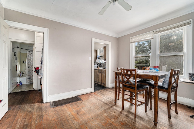 dining space featuring crown molding, dark hardwood / wood-style floors, and ceiling fan