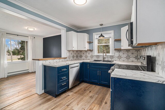 3143 US 31 N, Conway, MI 49722 - kitchen featuring blue cabinetry, a baseboard heating unit, open shelves, a sink, and appliances with stainless steel finishes
