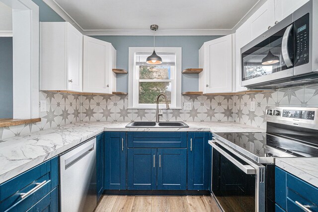 3143 US 31 N, Conway, MI 49722 - kitchen featuring blue cabinetry, appliances with stainless steel finishes, and open shelves