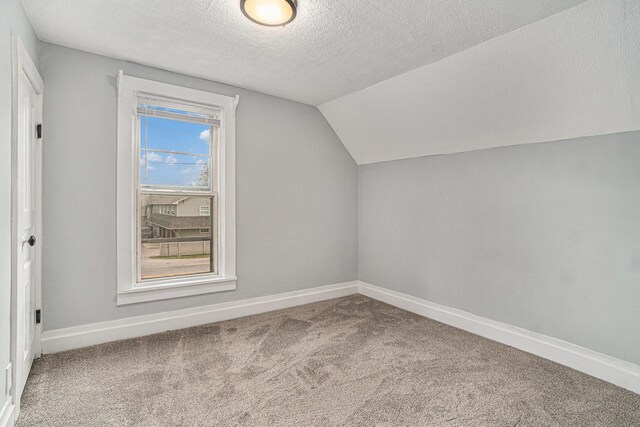 3143 US 31 N, Conway, MI 49722 - bonus room featuring carpet floors, baseboards, lofted ceiling, and a textured ceiling