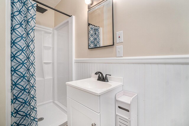 3143 US 31 N, Conway, MI 49722 - full bathroom featuring a wainscoted wall, a stall shower, and vanity