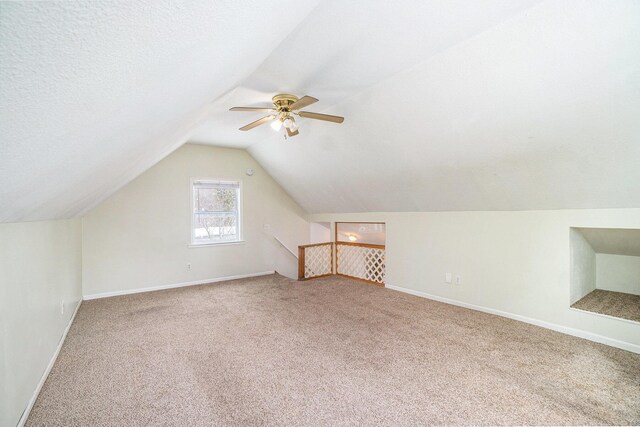 3143 US 31 N, Conway, MI 49722 - bonus room featuring carpet flooring, a textured ceiling, lofted ceiling, baseboards, and ceiling fan