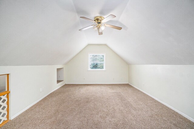 3143 US 31 N, Conway, MI 49722 - additional living space with baseboards, carpet flooring, lofted ceiling, and a ceiling fan