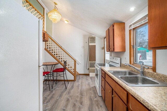 3143 US 31 N, Conway, MI 49722 - kitchen featuring white electric range oven, a sink, light wood-style floors, and brown cabinets
