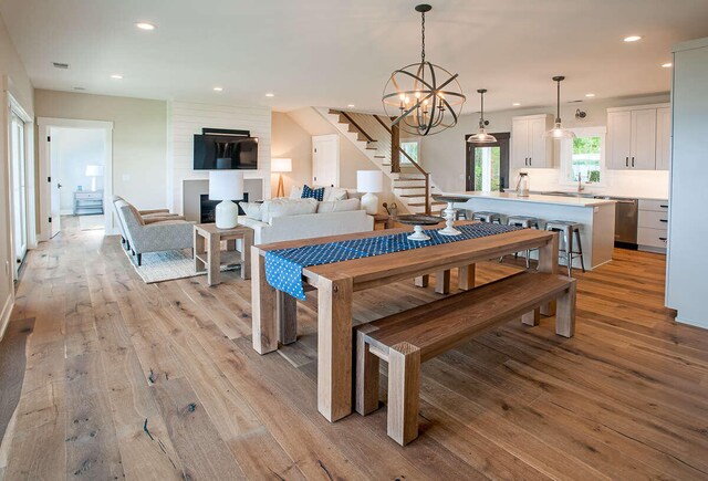 dining space with light wood-type flooring and a chandelier