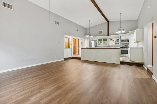 unfurnished living room with a notable chandelier, wood-type flooring, beamed ceiling, and high vaulted ceiling