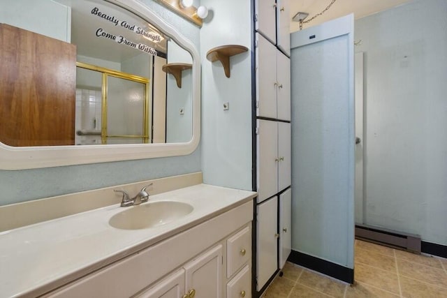 bathroom featuring tile patterned flooring, a shower with door, vanity, and a baseboard radiator