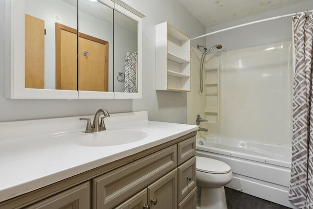 full bathroom featuring shower / tub combo with curtain, vanity, and toilet