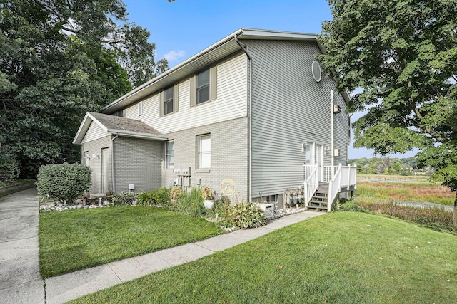 view of side of property featuring a yard