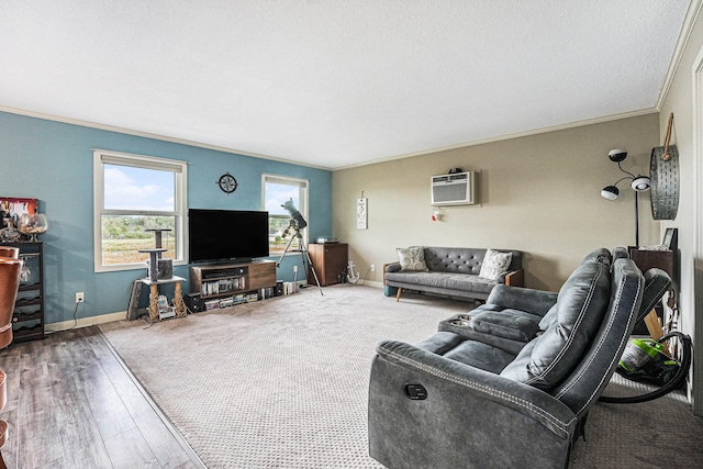 living room with ornamental molding, a textured ceiling, hardwood / wood-style floors, and a wall unit AC