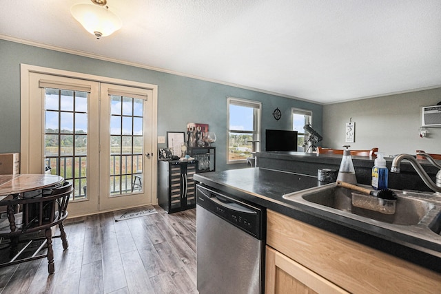 kitchen with dark hardwood / wood-style floors, sink, ornamental molding, french doors, and stainless steel dishwasher