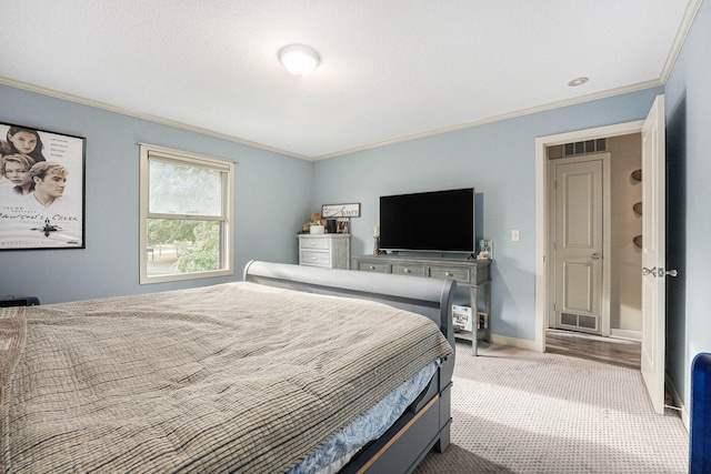 bedroom featuring carpet floors, a textured ceiling, and ornamental molding