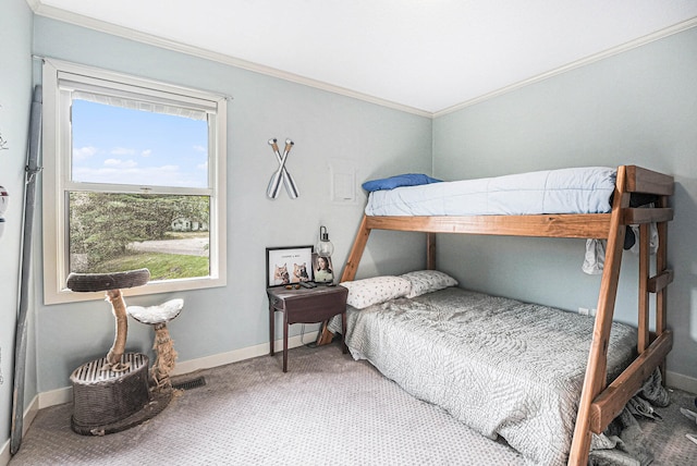 carpeted bedroom with ornamental molding