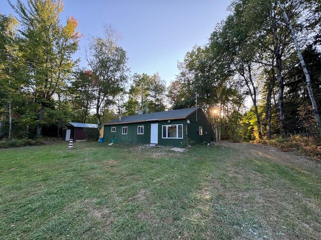 exterior space with a yard and a storage unit