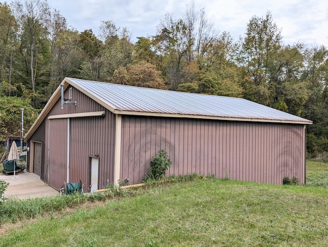 view of outbuilding with a garage and a yard