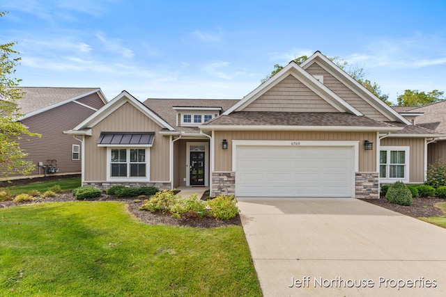 craftsman-style home with a front yard and a garage