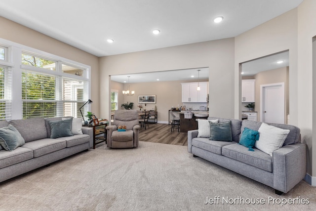 living room featuring a notable chandelier and carpet