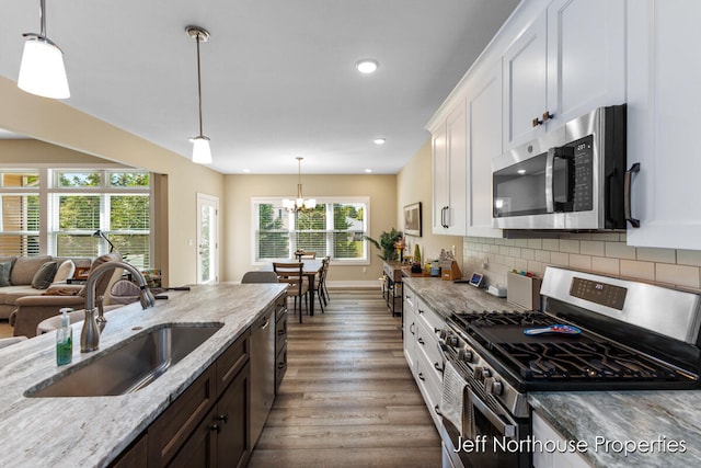 kitchen with stainless steel appliances, white cabinets, a wealth of natural light, and sink