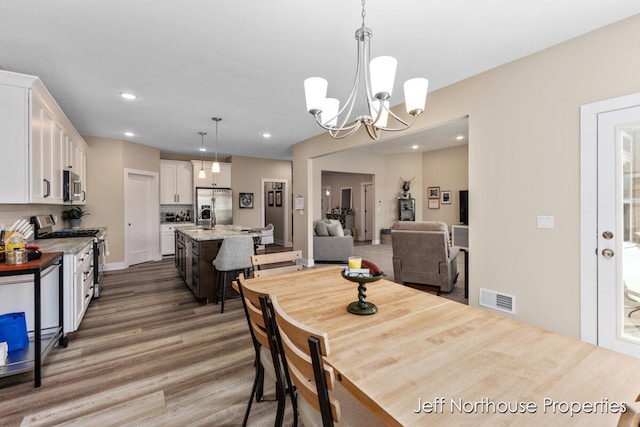 dining area with an inviting chandelier and dark hardwood / wood-style floors