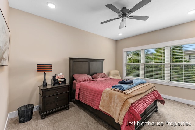 bedroom with ceiling fan and light colored carpet