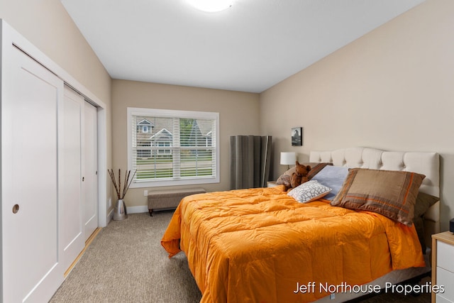 bedroom featuring light carpet and a closet