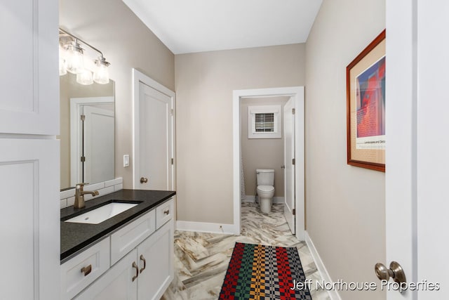 bathroom with vanity and toilet