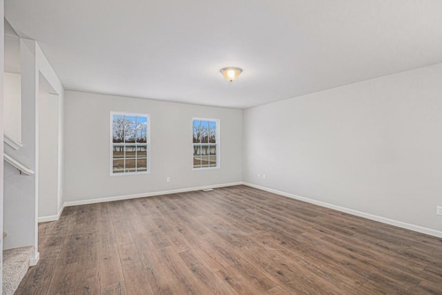 unfurnished room with hardwood / wood-style flooring