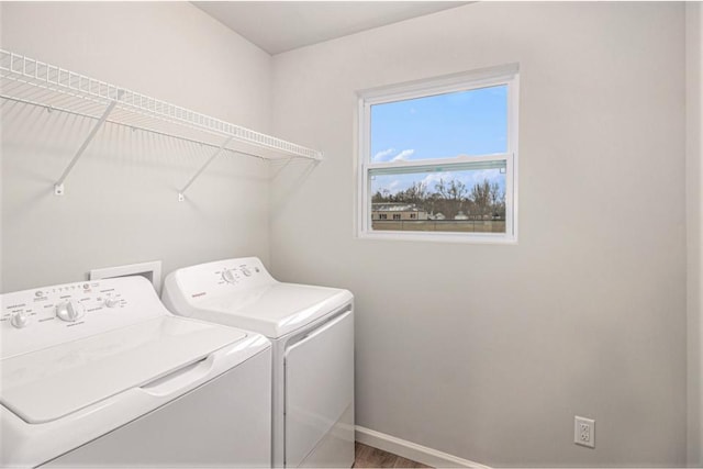 clothes washing area with washer and clothes dryer