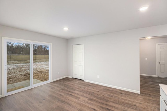 spare room with dark hardwood / wood-style flooring