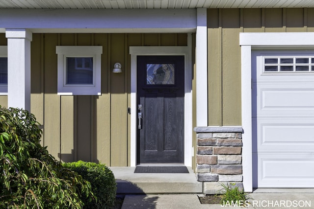 view of exterior entry featuring a garage