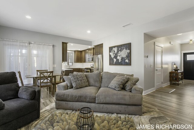 living room with dark hardwood / wood-style flooring