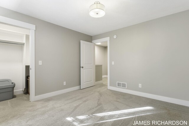 unfurnished bedroom featuring light carpet