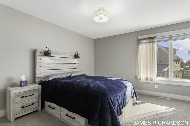 bedroom featuring light carpet