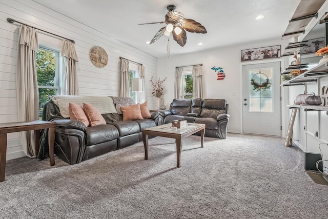 carpeted living room featuring ceiling fan