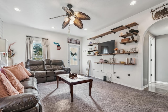 living room with ceiling fan and carpet floors