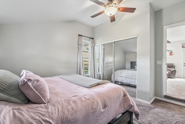 bedroom featuring ceiling fan, a closet, carpet, and lofted ceiling