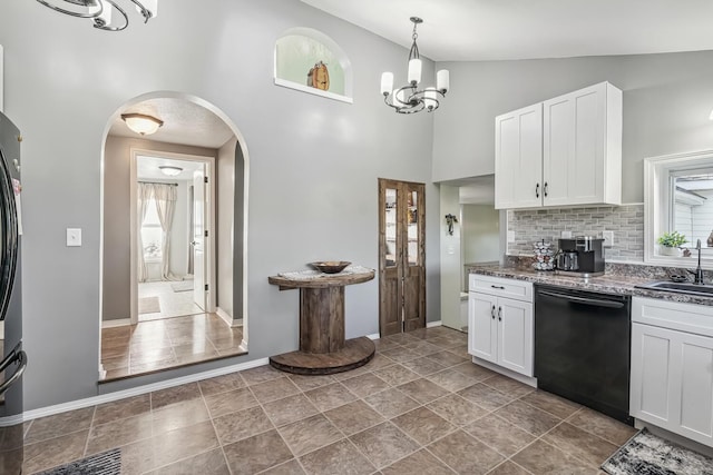 kitchen with backsplash, white cabinets, sink, black dishwasher, and a notable chandelier