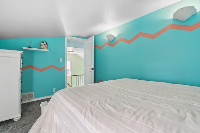 carpeted bedroom with lofted ceiling