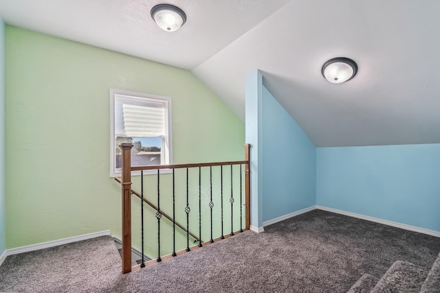 additional living space with carpet floors and lofted ceiling