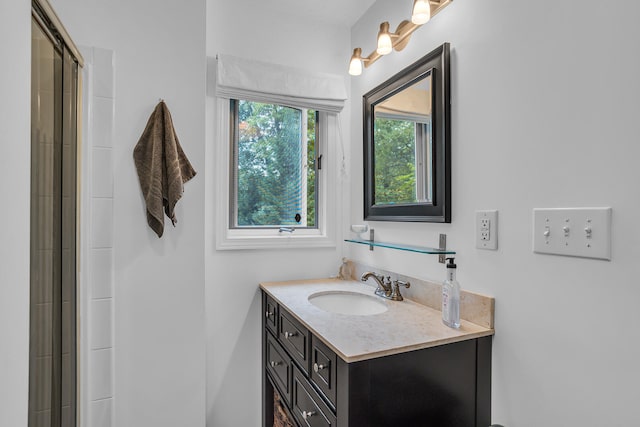 bathroom with vanity and a shower with shower door