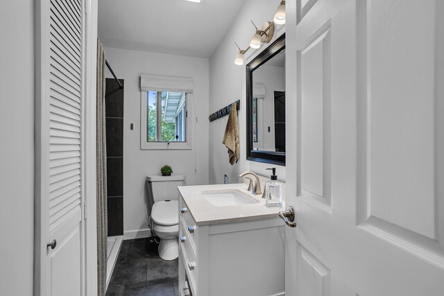 bathroom featuring vanity, toilet, and tile patterned floors