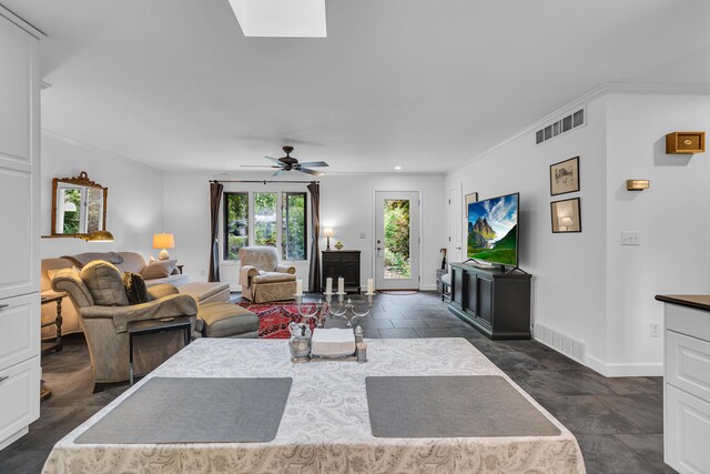 living room with ceiling fan and ornamental molding