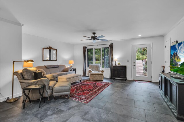 living room featuring ornamental molding, ceiling fan, and a healthy amount of sunlight