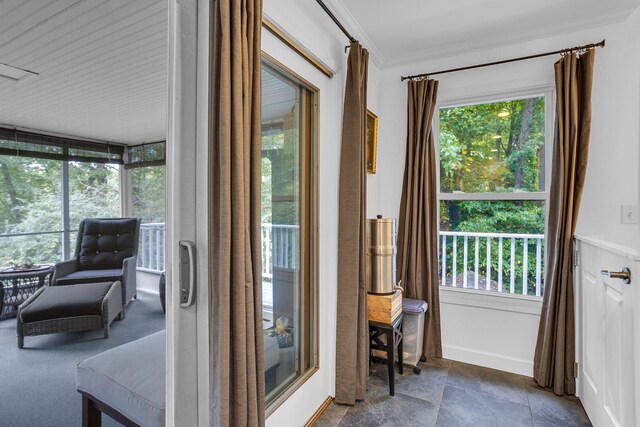 doorway to outside featuring ornamental molding