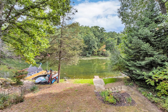 view of yard featuring a dock and a water view