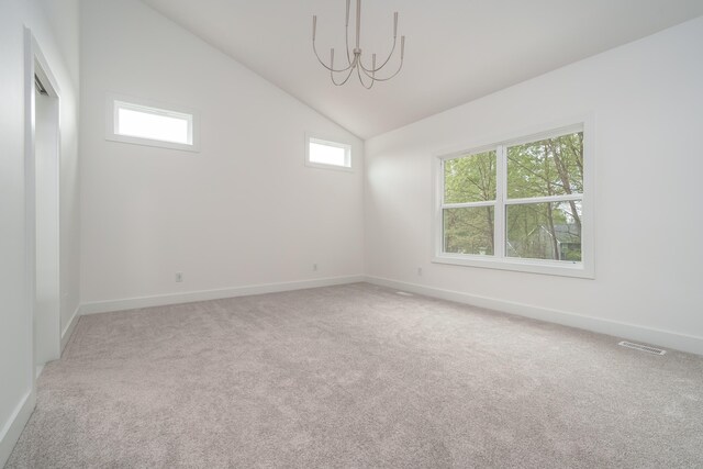 unfurnished room with carpet flooring, high vaulted ceiling, and a notable chandelier