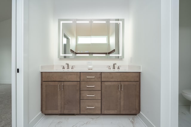 bathroom with vanity and toilet