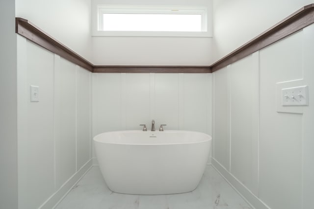 bathroom with a bathing tub and a wealth of natural light