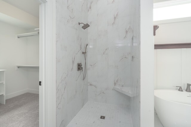 bathroom featuring shower with separate bathtub